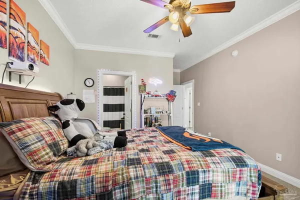 a bedroom with a bed and a chandelier