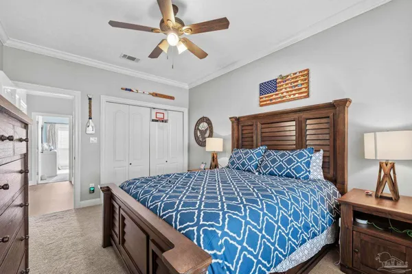 a bedroom with a large bed and a chandelier