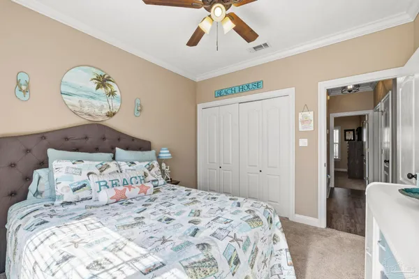 a bedroom with a bed and painting on the wall