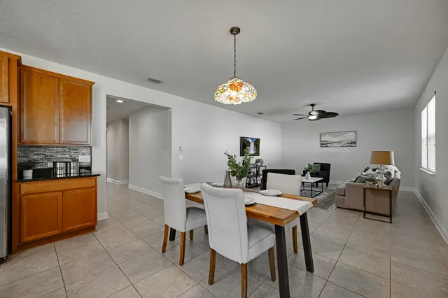 a kitchen island with granite countertop a sink and refrigerator