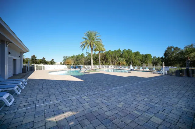 a view of a white house with a yard