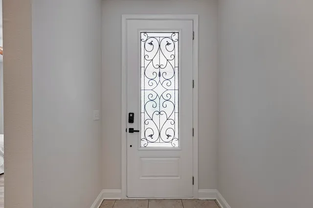 a view of a hallway with closet and a bathroom