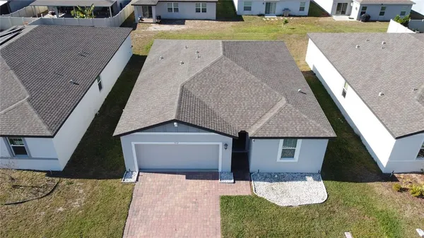 a aerial view of a house with a yard