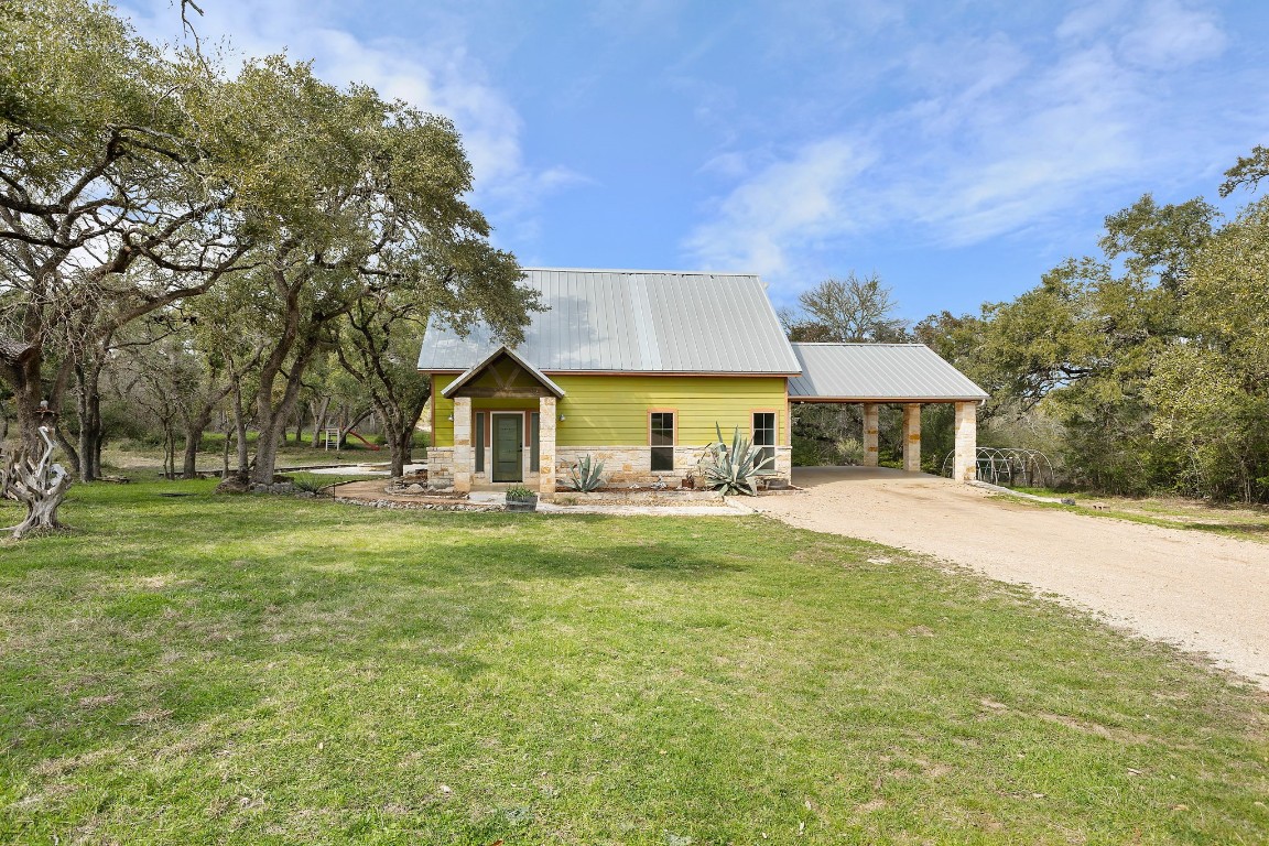 a front view of house with yard and trees