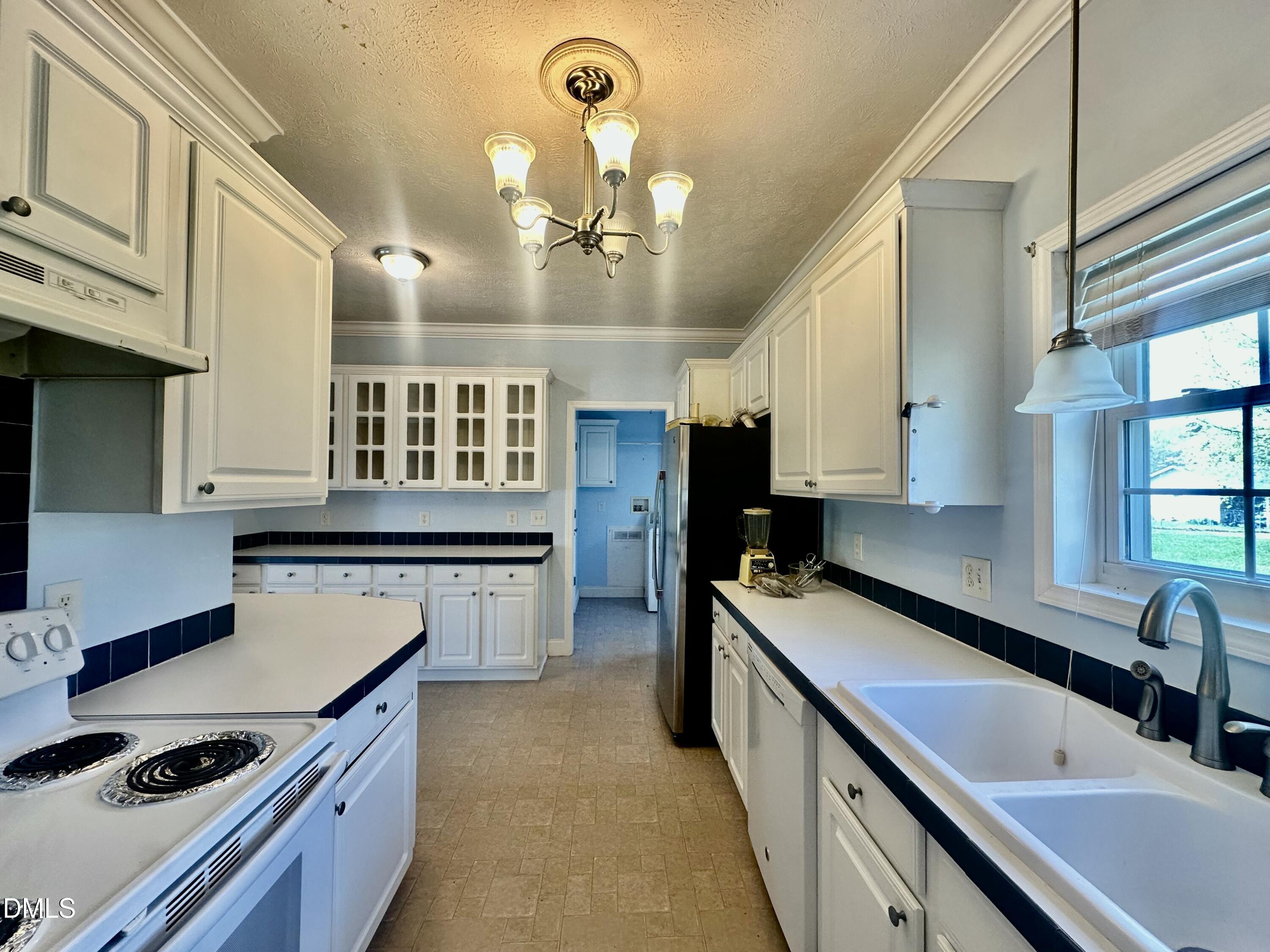 155 Collin Drive Roxboro, NC 27574 - Photo 7 of 20 a kitchen with stainless steel appliances a sink stove and refrigerator