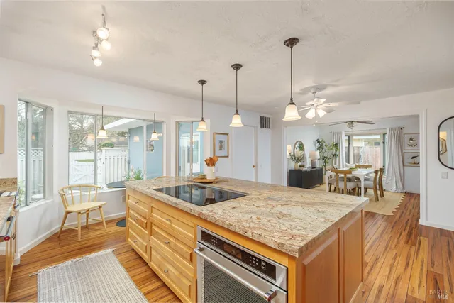 a kitchen with sink stove and dining table