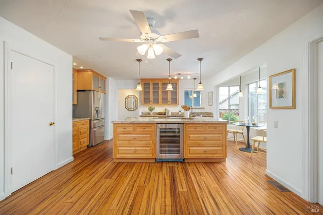 a view living room with wooden floor and ceiling fan