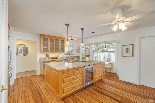 a kitchen with a sink and wooden floor