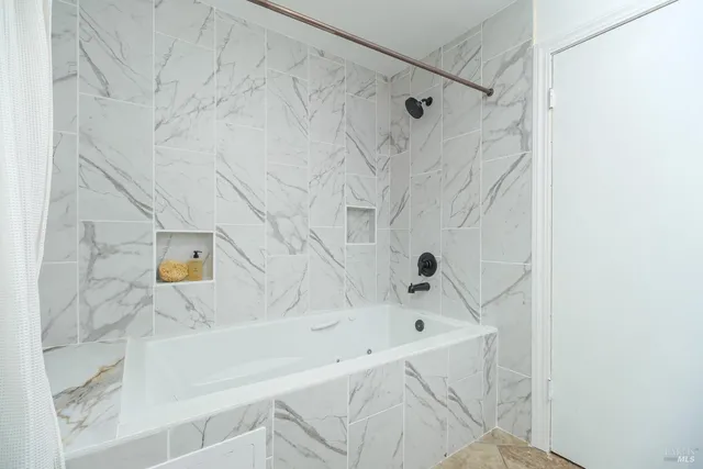 a bathroom with a tub and a shower