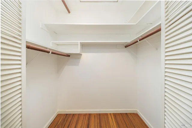 a view of walk in closet with empty racks