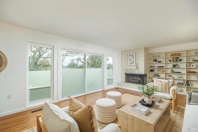 a living room with furniture and a floor to ceiling window