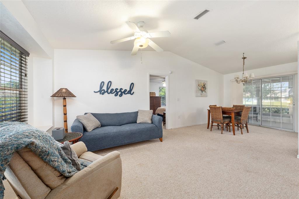 8038 Southwest 108th Loop Ocala, FL 34481 - Photo 8 of 48 a living room with furniture and a chandelier