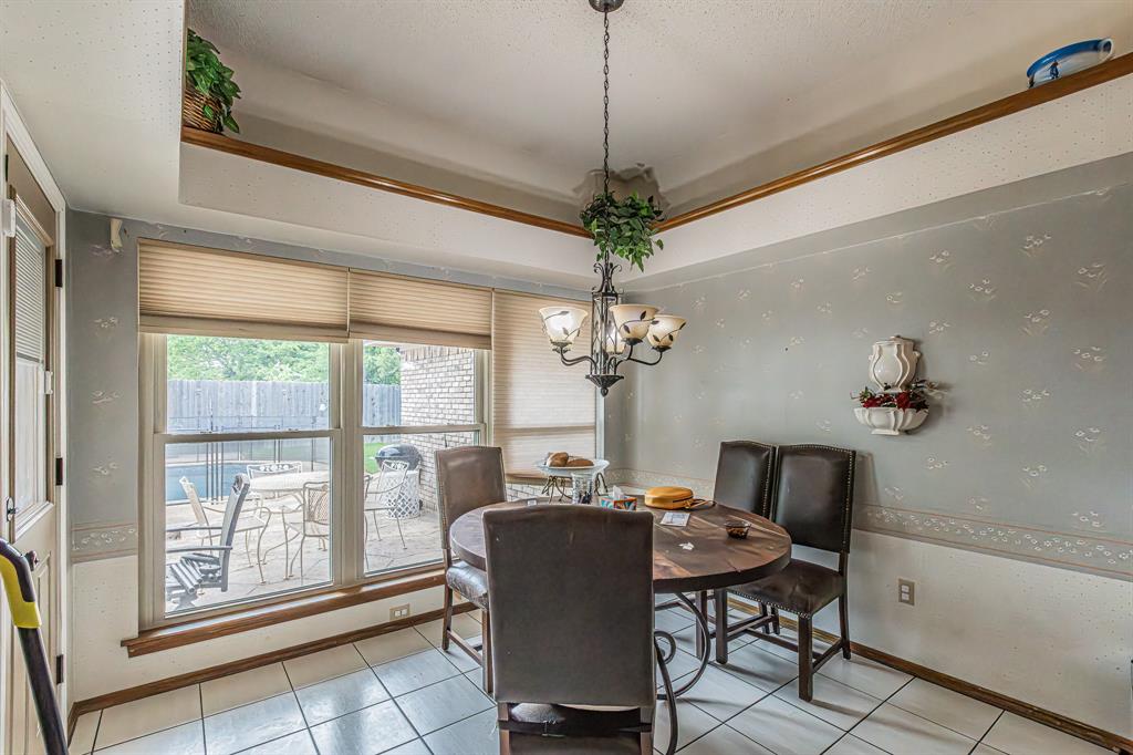 3309 Timber View Circle Bedford, TX 76021 - Photo 8 of 38 a dining room with furniture a chandelier and window