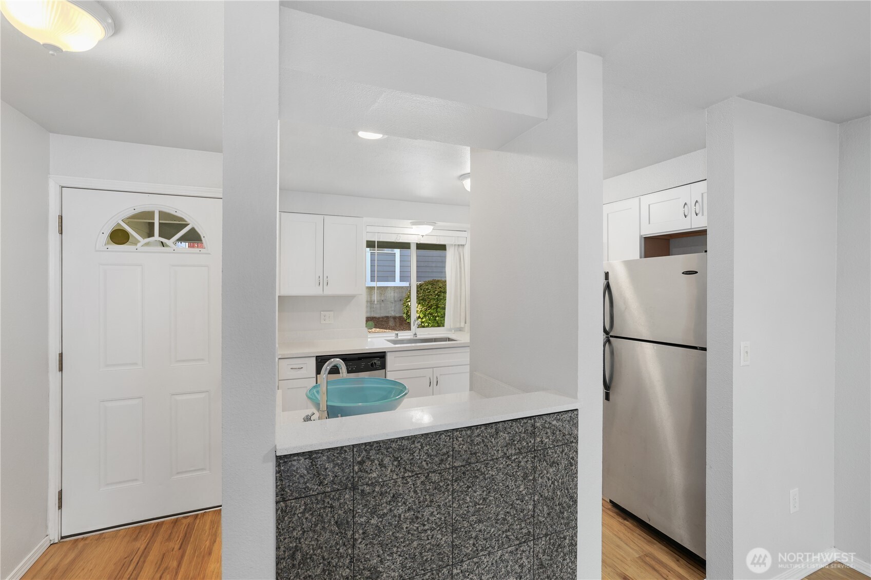 1010 North J Street, Unit 2 Tacoma, WA 98403 - Photo 4 of 29 a kitchen with a refrigerator and a sink