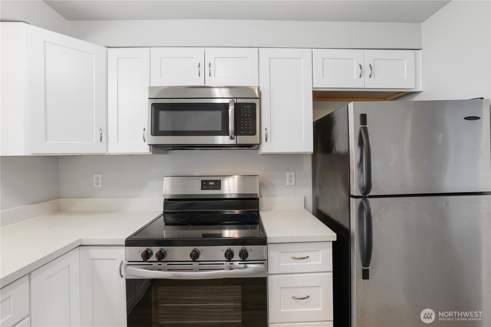 1010 North J Street, Unit 2 Tacoma, WA 98403 - Photo 9 of 29 a kitchen with stainless steel appliances a stove microwave and refrigerator