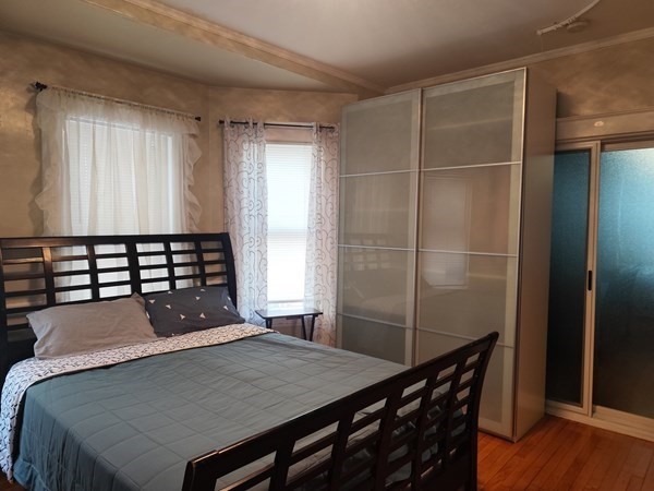 240 Sycamore Street, Unit 1 Watertown, MA 02472 - Photo 1 of 5 a bed sitting in a bedroom next to a window