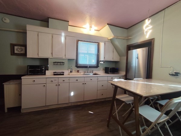 240 Sycamore Street, Unit 1 Watertown, MA 02472 - Photo 5 of 5 a kitchen with a sink cabinets and wooden floor