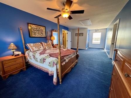 610 Rolling Meadows Lane Rickman, TN 38580 - Photo 15 of 42 a bedroom with a bed and a chandelier