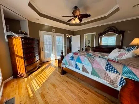 a bedroom with a bed dresser and a window
