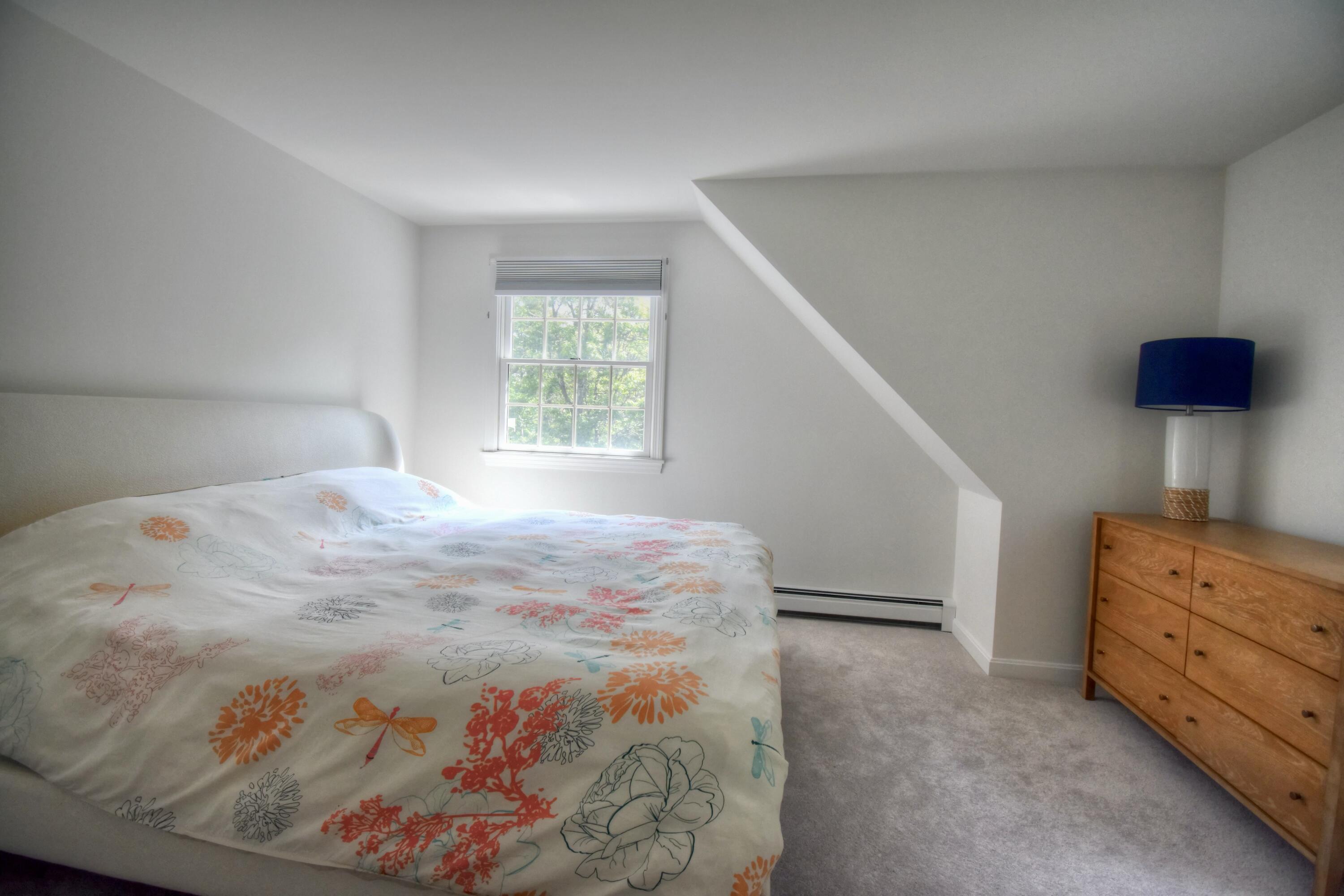 41 Turning Mill Road Brewster, MA 02631 - Photo 19 of 44 a bedroom with a bed and a window