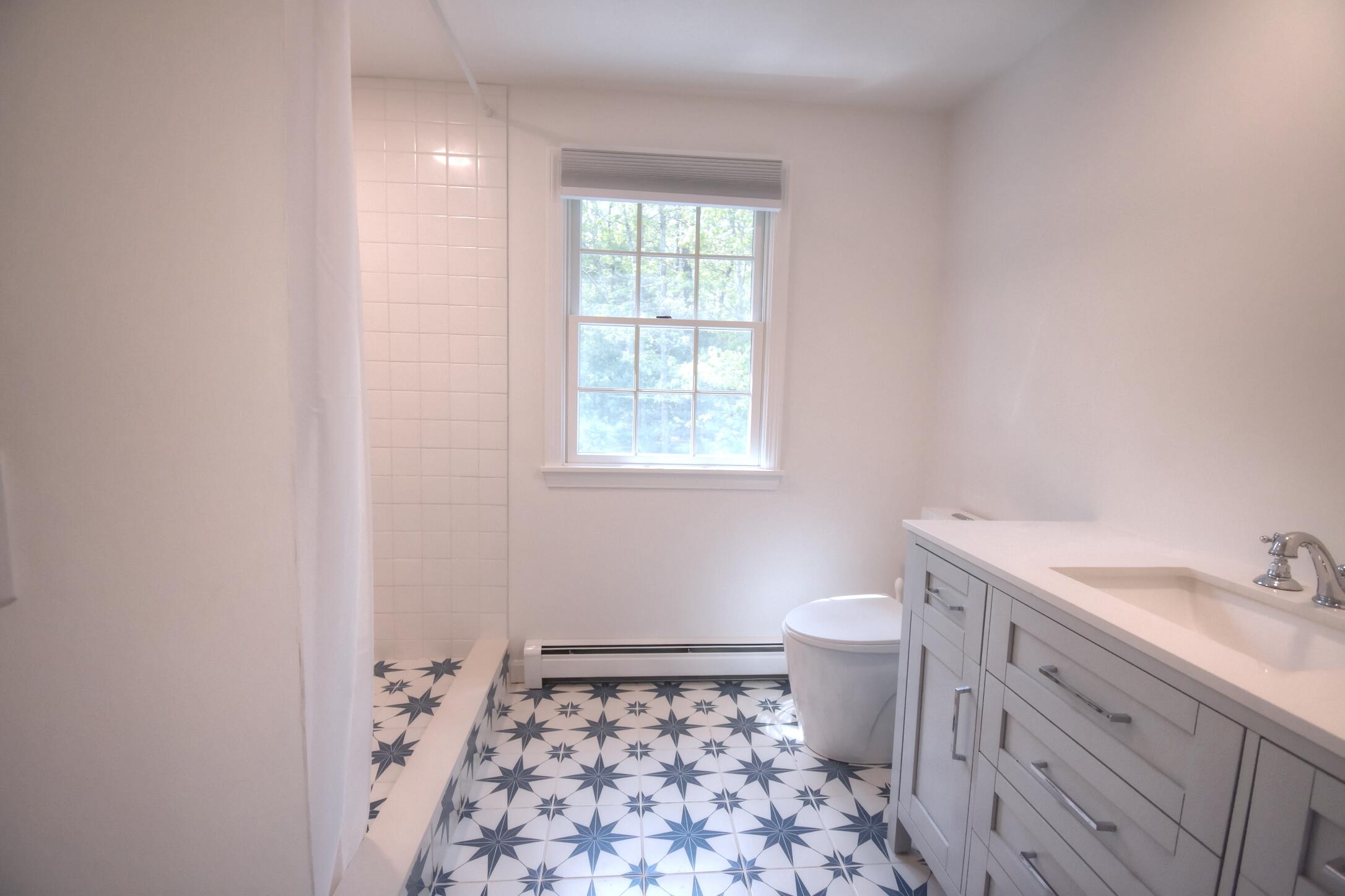 41 Turning Mill Road Brewster, MA 02631 - Photo 24 of 44 a bathroom with a sink toilet and window