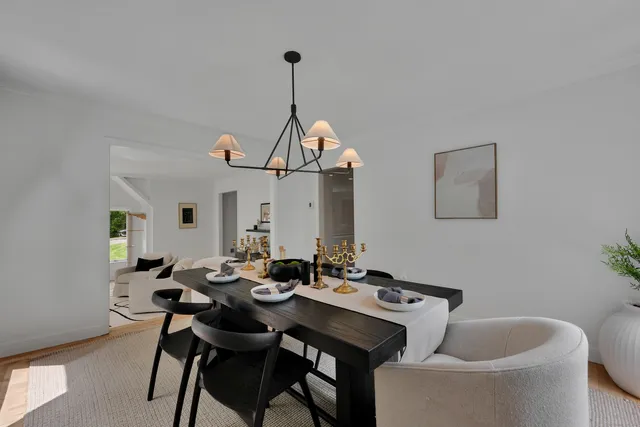 a view of a dining room with furniture and chandelier
