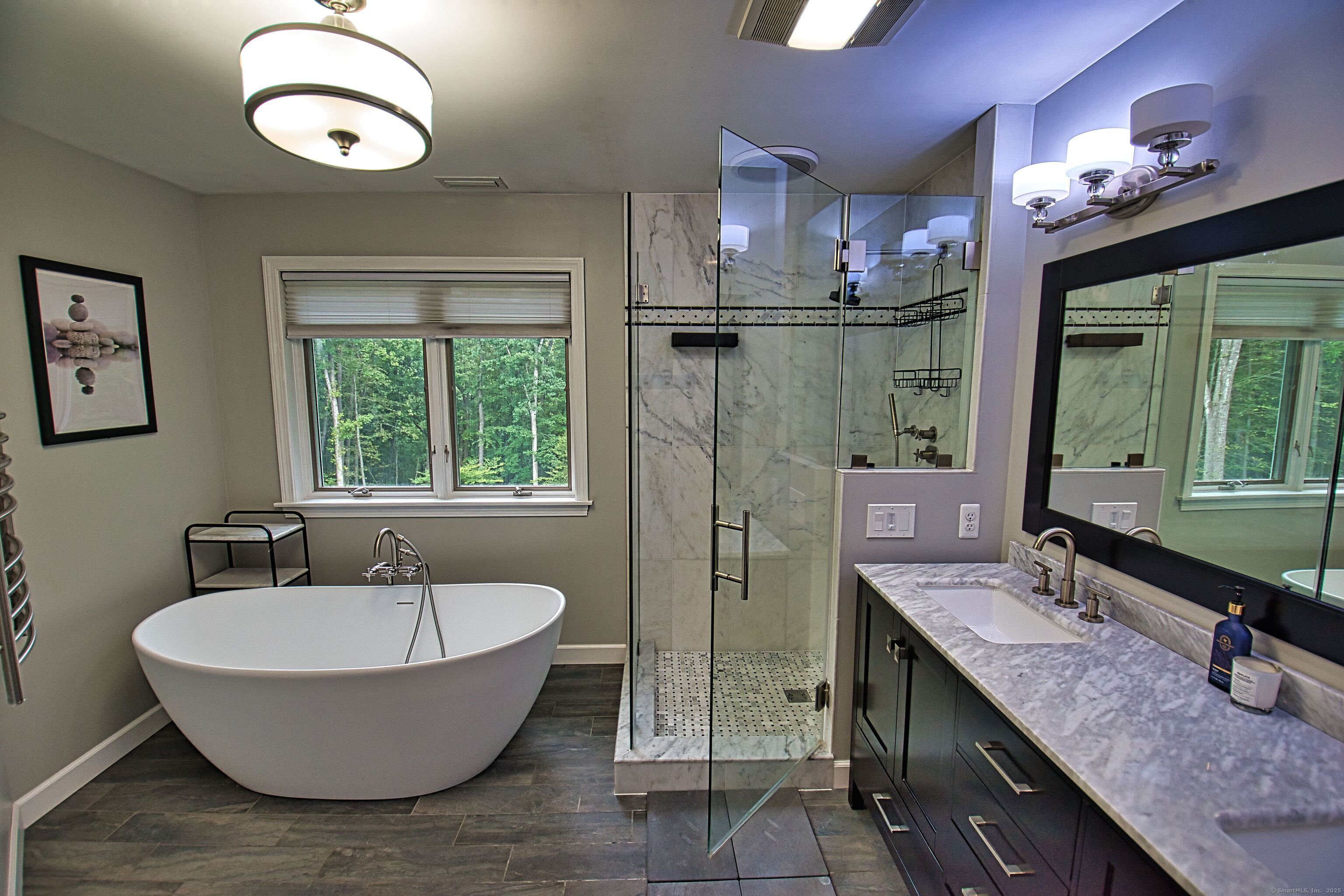 60 Wildcat Road Burlington, CT 06013 - Photo 22 of 39 a spacious bathroom with a granite countertop sink a mirror and a bathtub