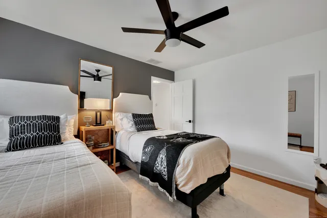 a bedroom with a bed and a chandelier