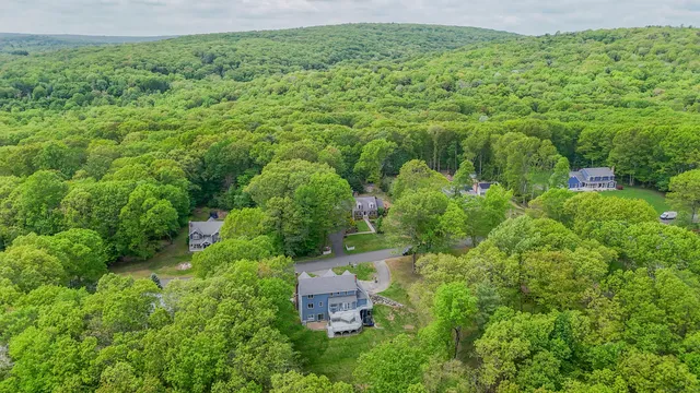 an aerial view of a house with a yard