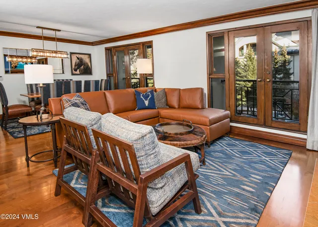 a living room with furniture a rug and a window