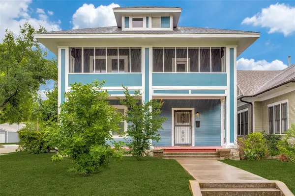 a front view of a house with a yard and porch