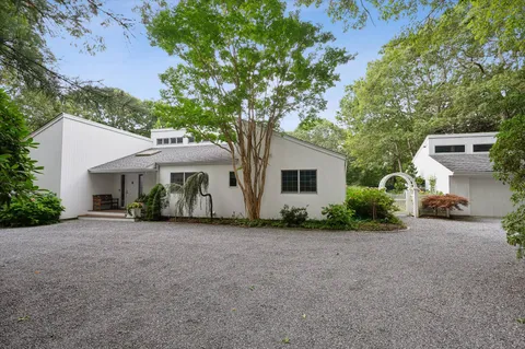 a view of a house with a patio and a yard