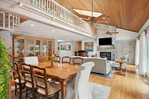 a view of a dining room with furniture wooden floor and chandelier