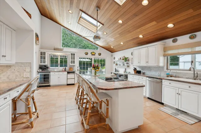 a kitchen with granite countertop a sink stove and cabinets