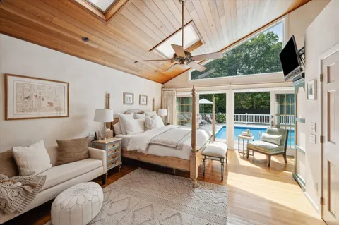 a bed room with furniture and a large window