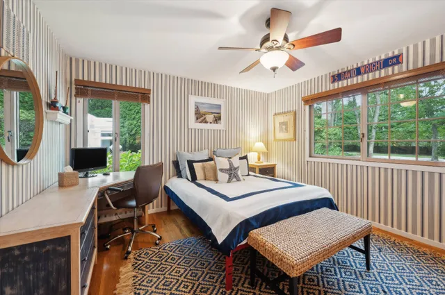 a bedroom with a bed a chandelier and a window