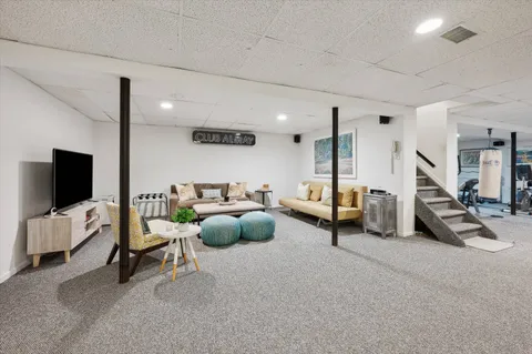 a bedroom with furniture and a flat screen tv