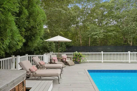 a view of balcony with wooden floor and outdoor seating