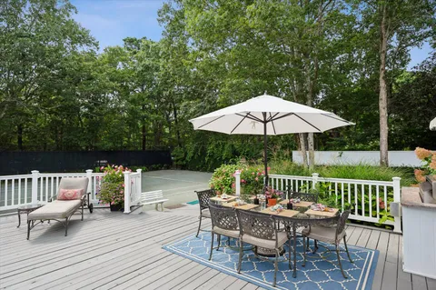 a view of backyard with seating space and trees