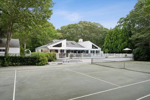 a white building with a bench in front of it