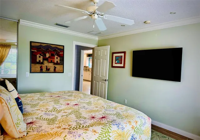 a bedroom with a bed and a flat screen tv