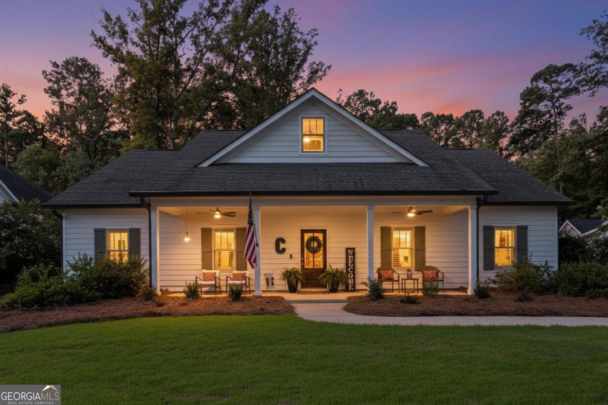 a front view of house with yard outdoor seating and green space