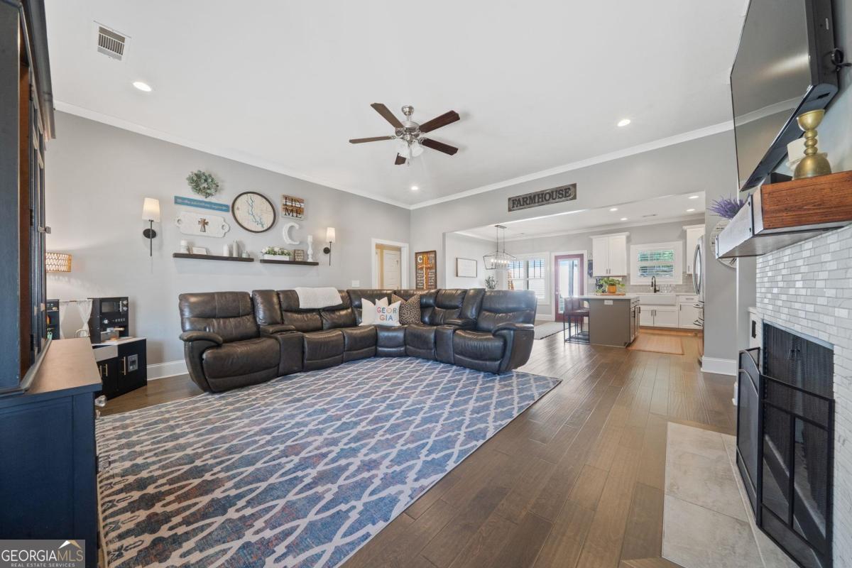 757 Markhams Drive Madison, GA 30650 - Photo 13 of 46 a living room with furniture and a fireplace