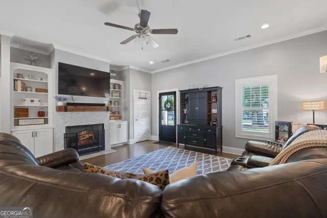 a living room with furniture a flat screen tv and a fireplace