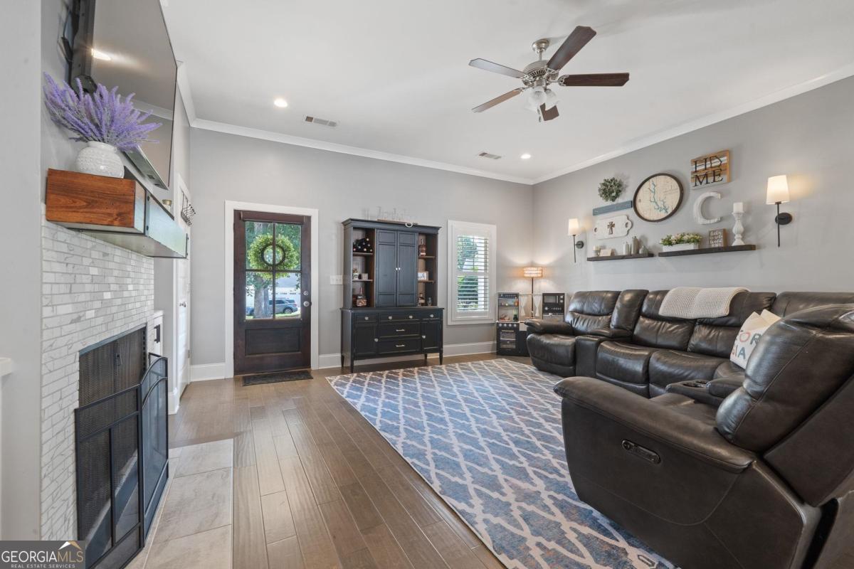 757 Markhams Drive Madison, GA 30650 - Photo 15 of 46 a living room with furniture and a fireplace