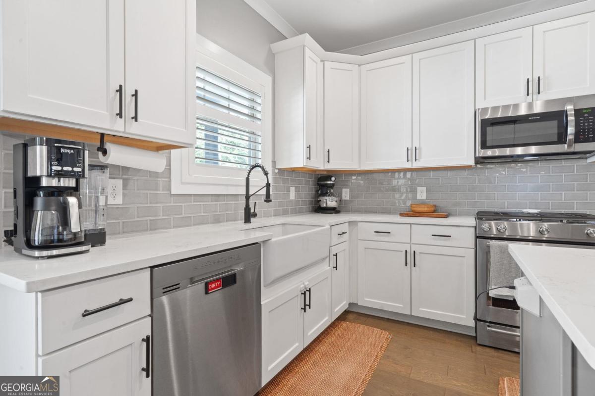 757 Markhams Drive Madison, GA 30650 - Photo 17 of 46 a kitchen with cabinets appliances a sink and a counter top space