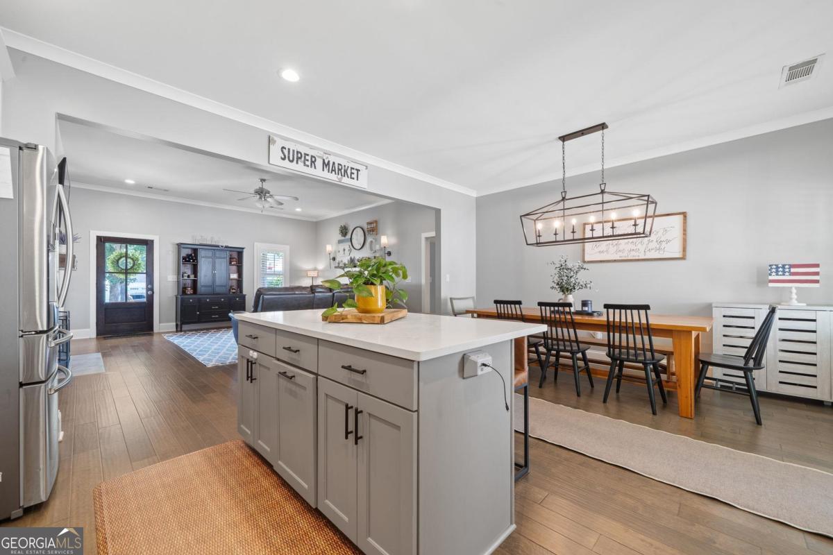 757 Markhams Drive Madison, GA 30650 - Photo 18 of 46 a view of a dining room with furniture and wooden floor