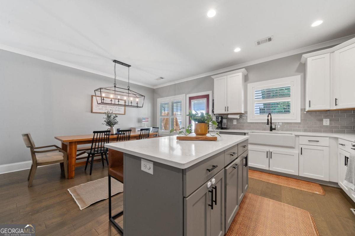 757 Markhams Drive Madison, GA 30650 - Photo 19 of 46 a kitchen with a counter space a sink appliances and cabinets