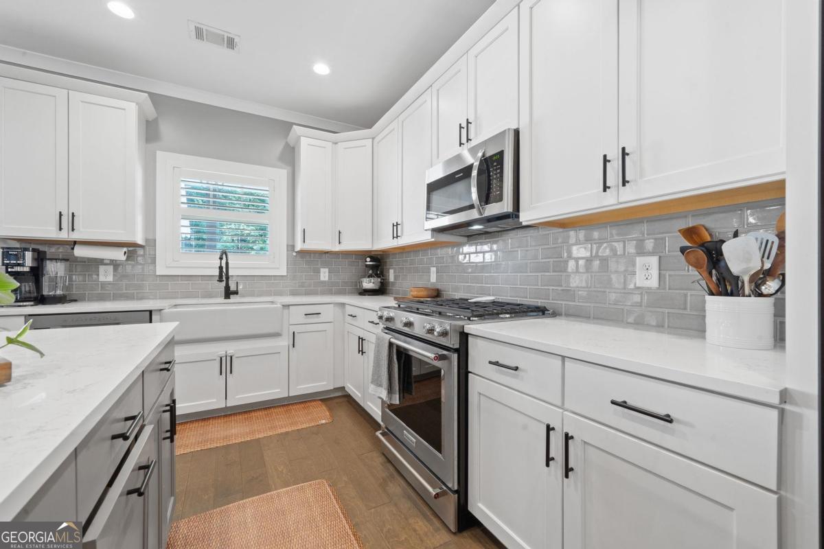 757 Markhams Drive Madison, GA 30650 - Photo 20 of 46 a kitchen with stainless steel appliances granite countertop white cabinets a sink and dishwasher