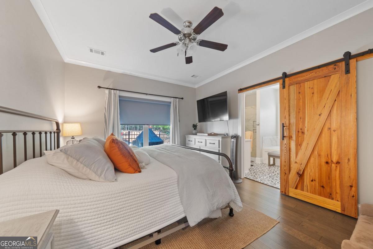 757 Markhams Drive Madison, GA 30650 - Photo 27 of 46 a bedroom with a bed and a large window